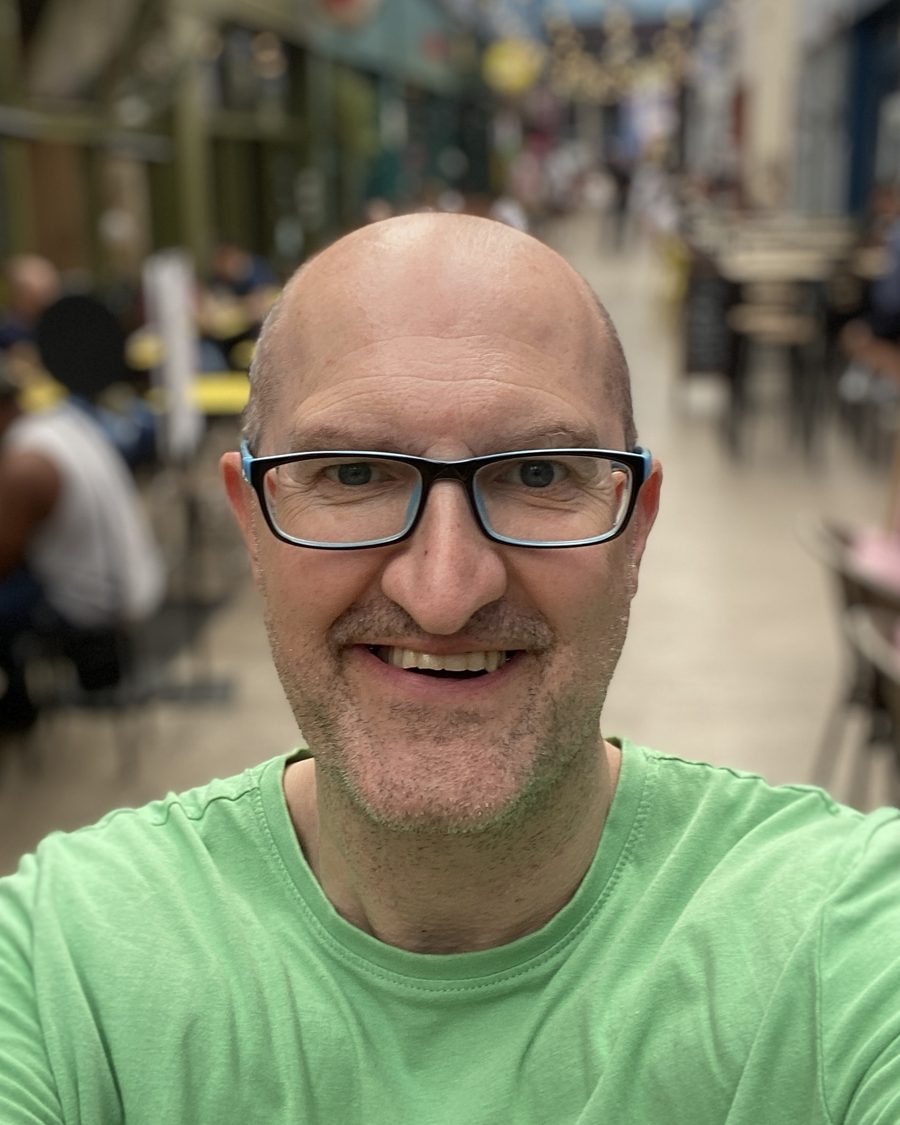Andrew Wallis smiling, in a covered shopping arcade